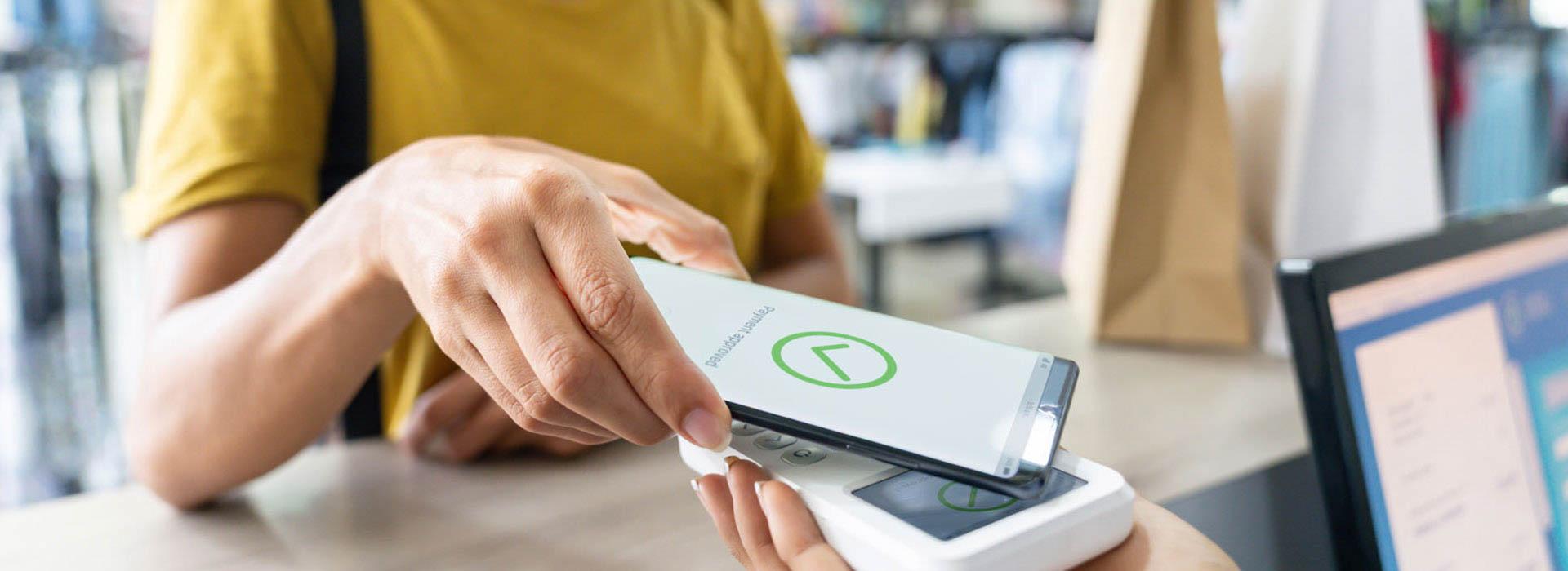 lady doing tap to pay with her cellphone