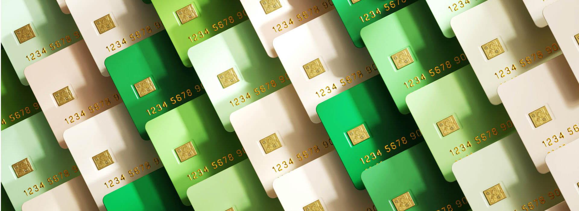a variety of credit cards in a variety of green shades overlapping each other