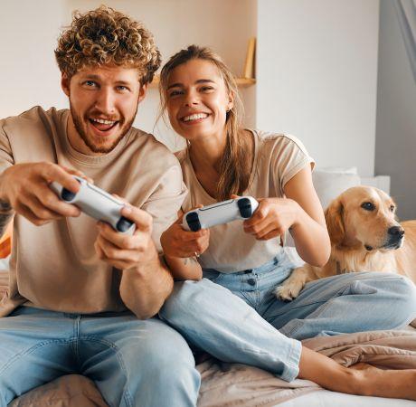 couple with dog playing video game