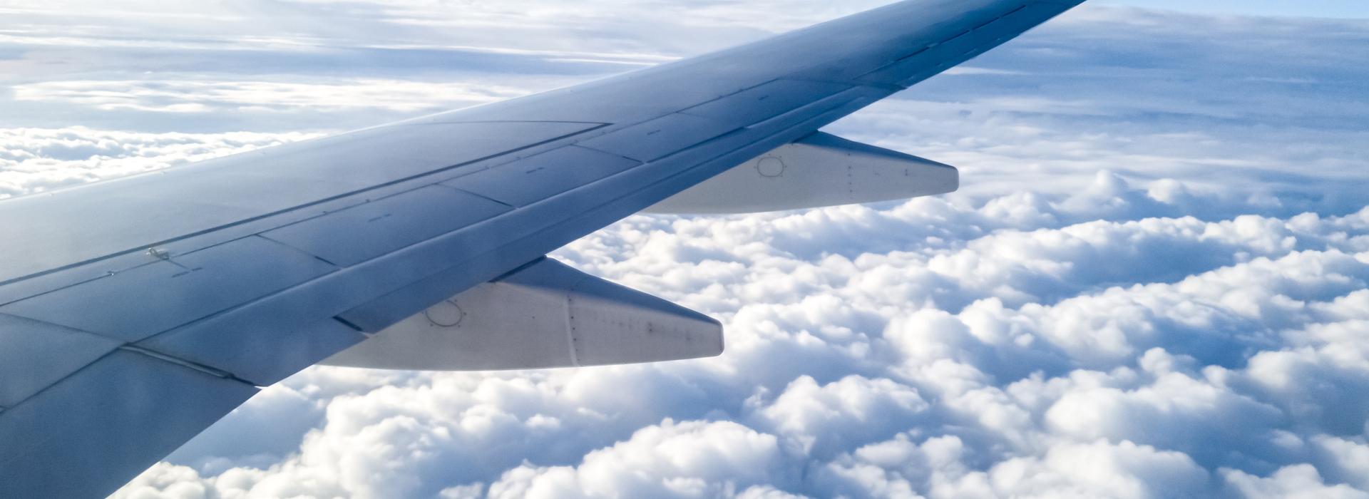 Airplane in air with surrounding clouds